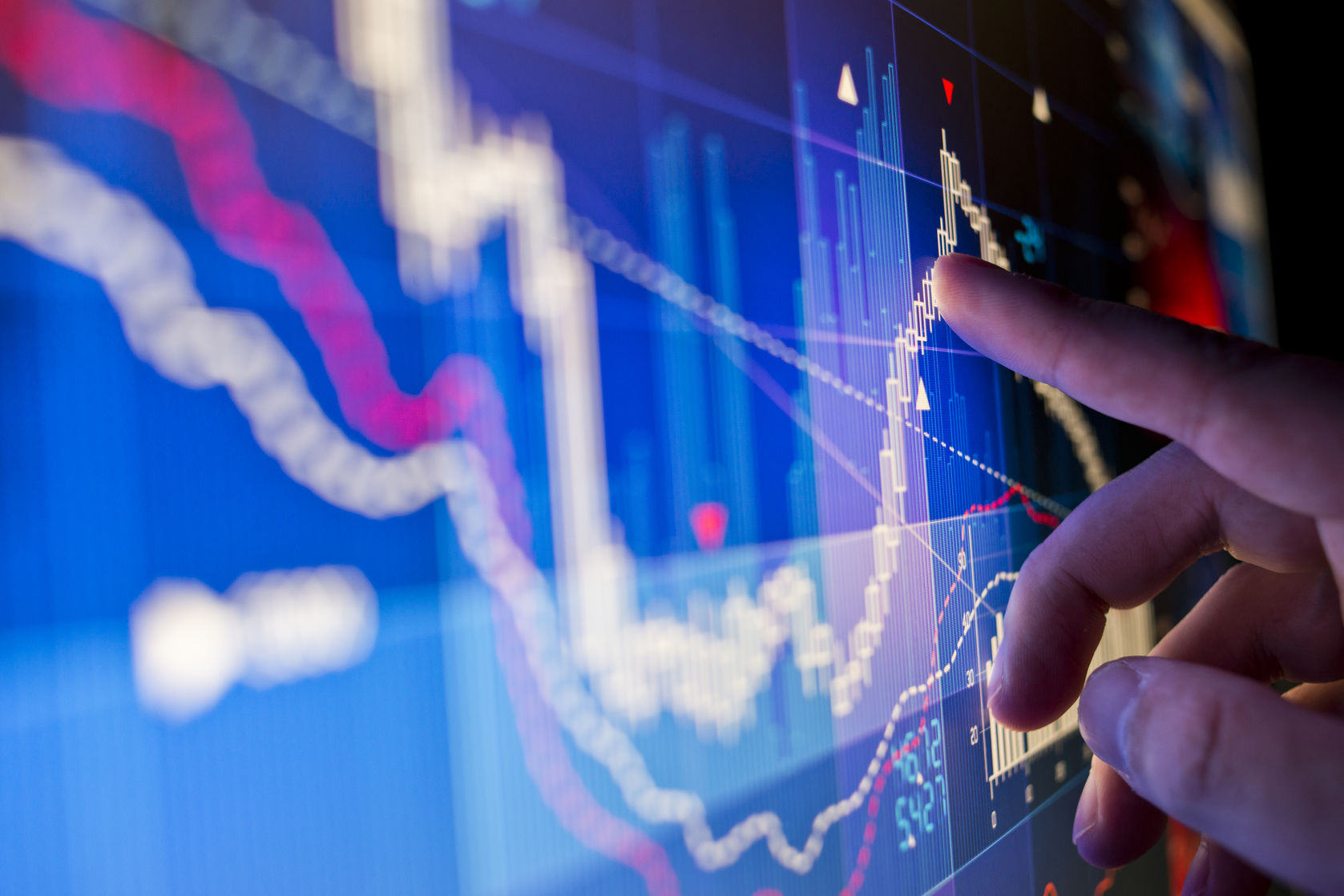 a city worker analysing stock market data on a monitor.