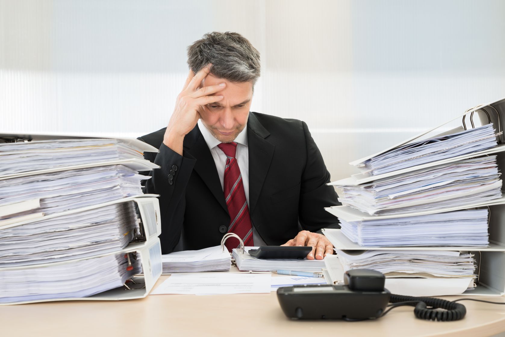 photo of contemplated businessman working at office