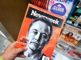 Elon musk Newsweek magazine in a hand.