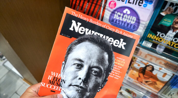 Elon musk Newsweek magazine in a hand.